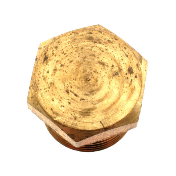 A close-up of a gold hexagon shaped brass nut.