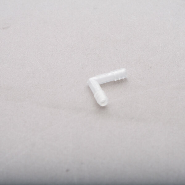 A white plastic connector on a white surface.