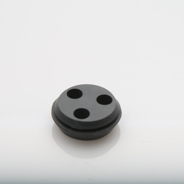 A black Glastender rubber grommet with four holes.