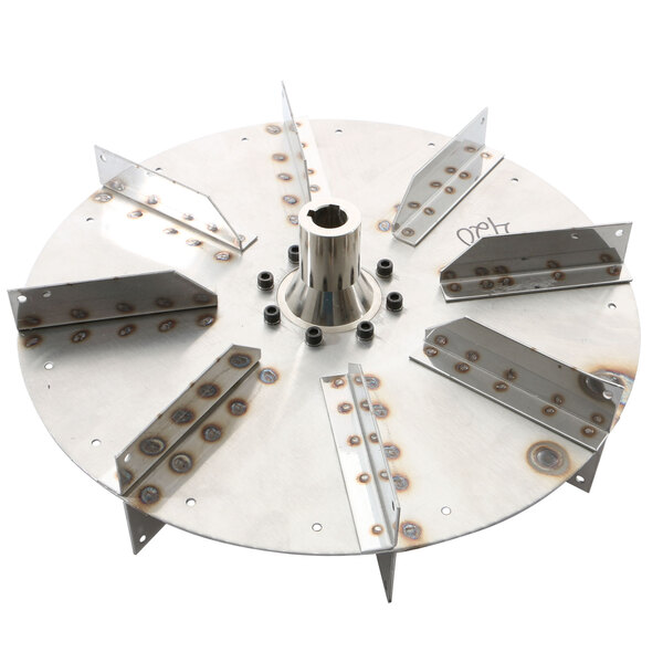 A close-up of a metal circular Doyon Baking Equipment blower wheel with holes.