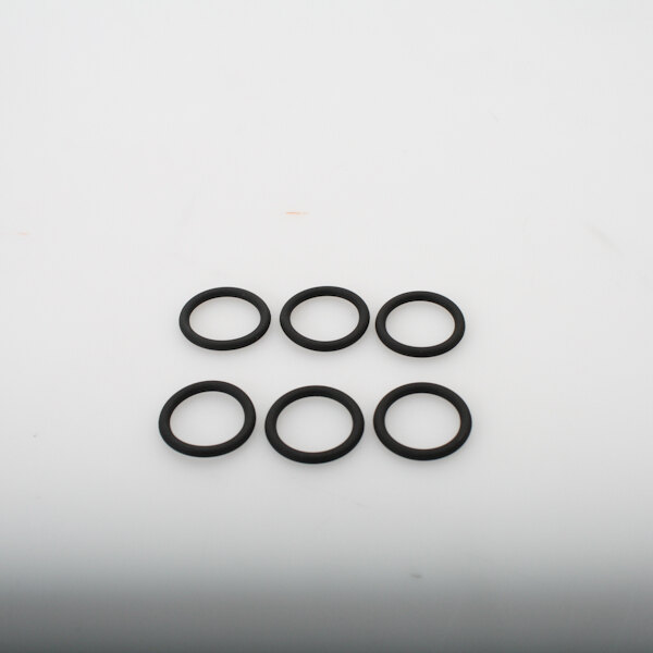 A group of black rubber o rings on a white surface.