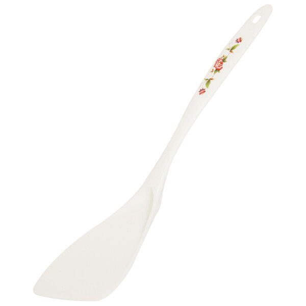 A white plastic spatula with a floral design.