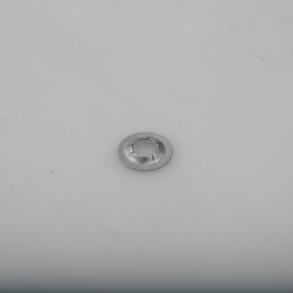 A close up of a silver round metal washer on a white surface.