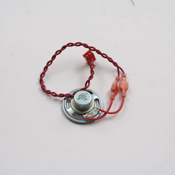 A round metal object with red and white wires.