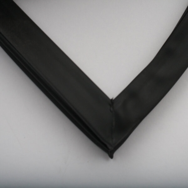 A black rubber corner on a white surface.