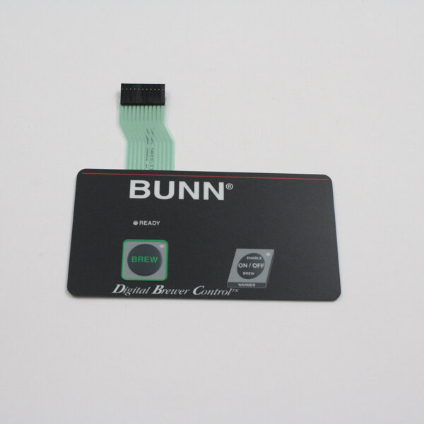 A close up of a grey and green Bunn smart card reader.