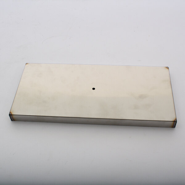 A white rectangular metal plate with a hole in it.