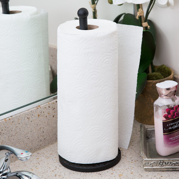 A Tablecraft black paper towel holder with a roll of paper towels on a counter.