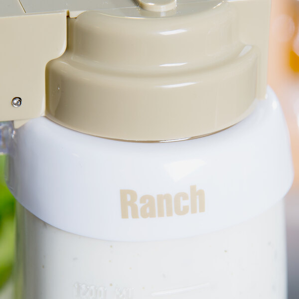 A white Tablecraft plastic bottle with beige lettering on the collar filled with white liquid.