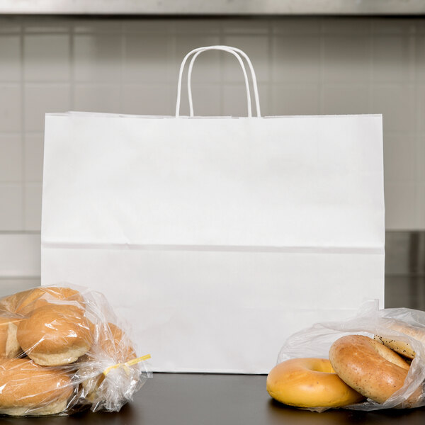 A Duro white paper shopping bag with a bagel and bagels inside.