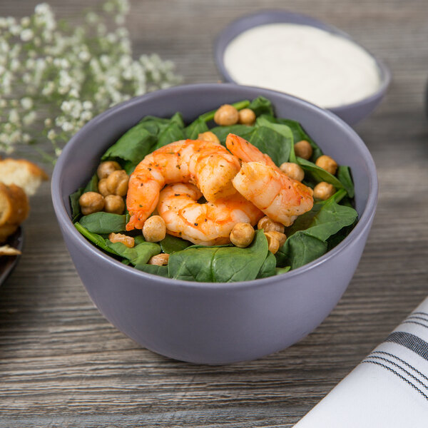 A Libbey Driftstone porcelain bowl filled with spinach and shrimp on a table.