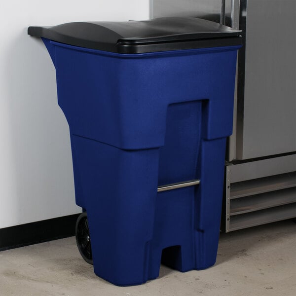 A Rubbermaid blue wheeled rectangular trash can with a black lid.