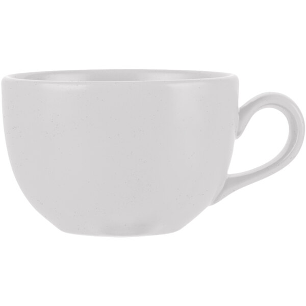 A close-up of a white cup with a handle.