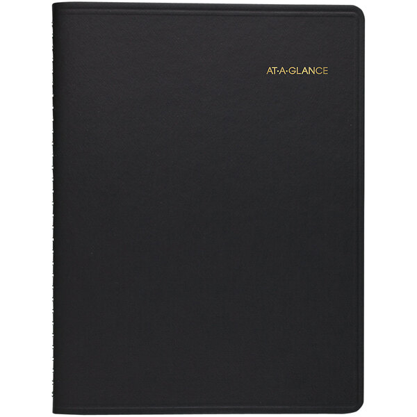 A black notebook with gold text on the cover.