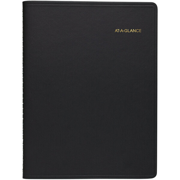 A black leather At-A-Glance weekly planner with gold text on the cover.