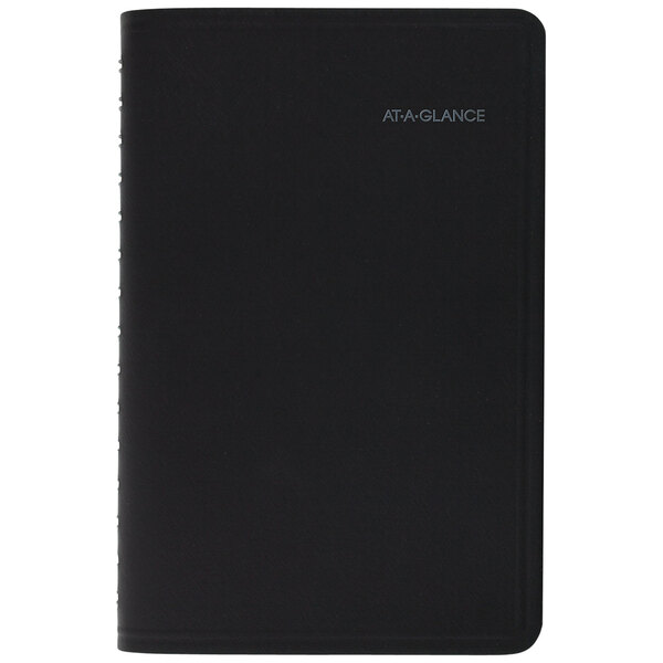 A black At-A-Glance QuickNotes monthly planner with silver writing on the cover.