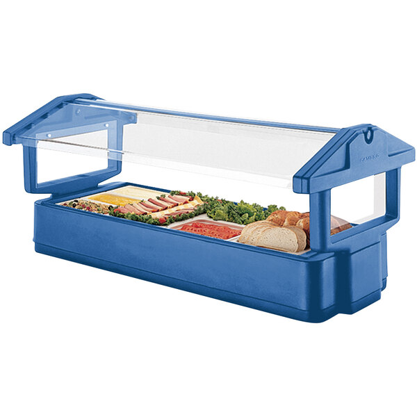 A navy blue Cambro table top food and salad bar with food inside.