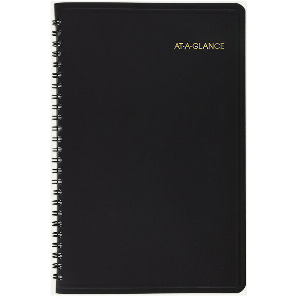 A black At-A-Glance spiral bound appointment book with gold writing on the cover.