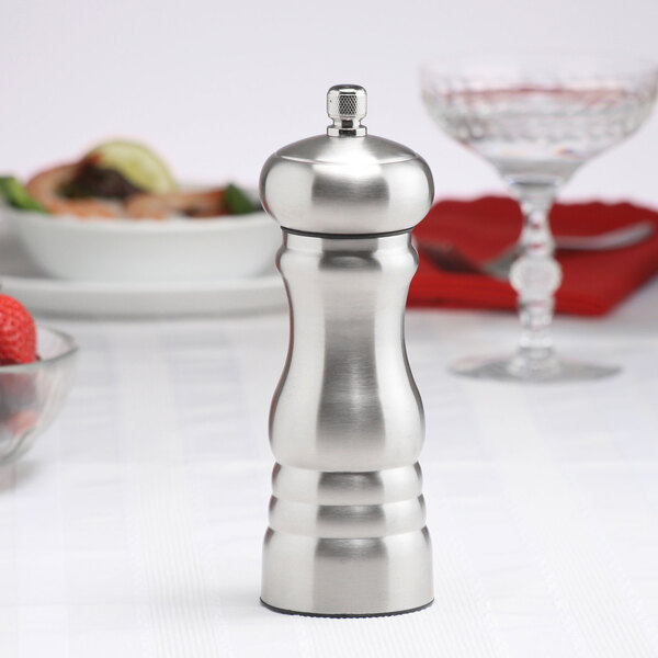 A Chef Specialties stainless steel pepper mill on a table.
