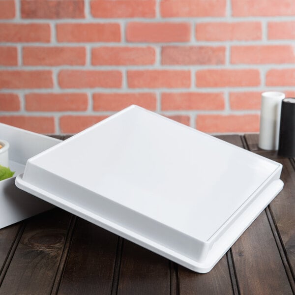 A white Elite Global Solutions melamine box lid on a white square tray.