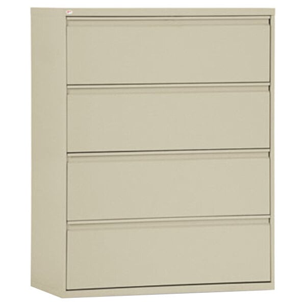 A putty metal filing cabinet with four drawers.