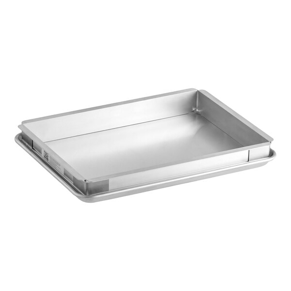 A rectangular metal half size extender and bun pan sheet cake pan set.