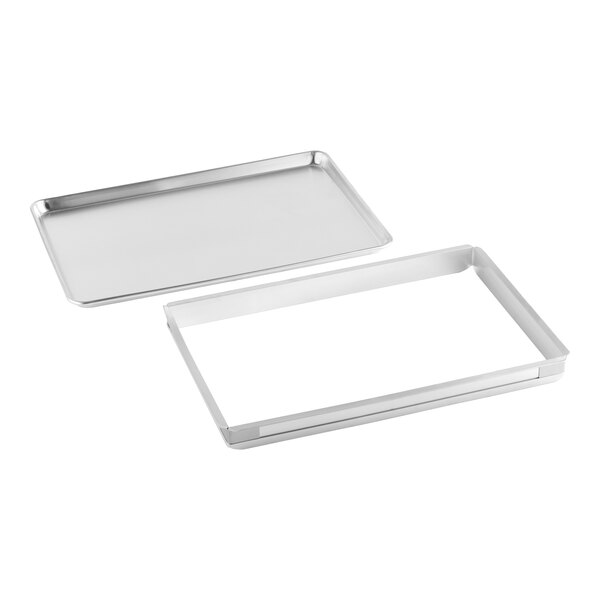 A full size metal sheet cake pan set with an extender and a bun pan.
