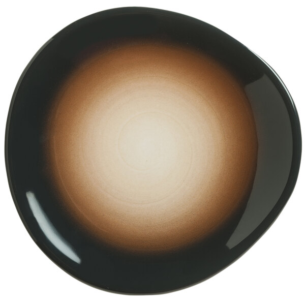 A white porcelain plate with a black and brown circular design.