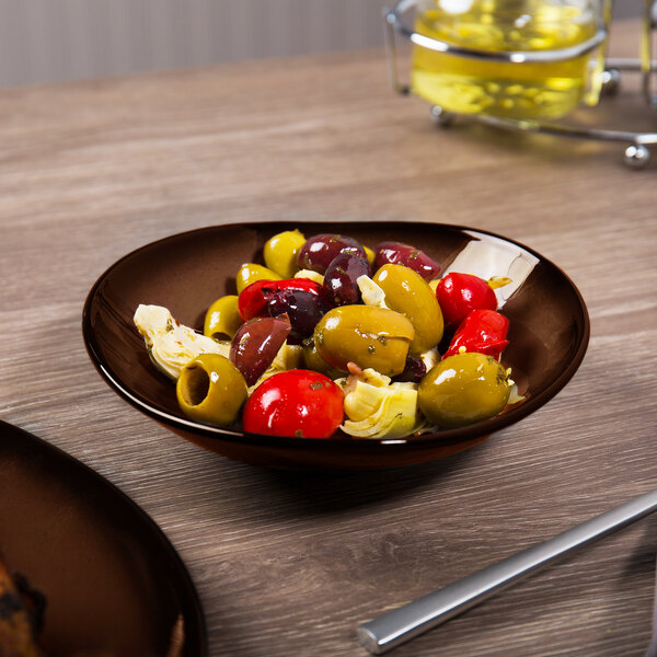 A Reserve by Libbey Tiger Porcelain Bowl filled with olives and artichokes on a table.