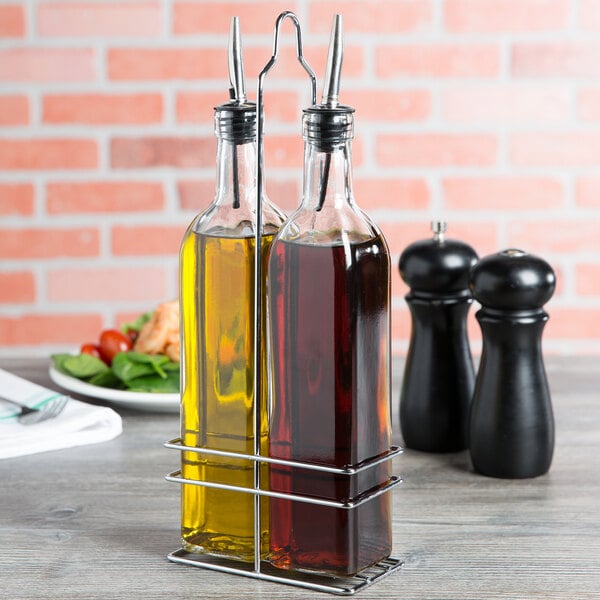 A metal rack holding two Choice oil and vinegar bottles.