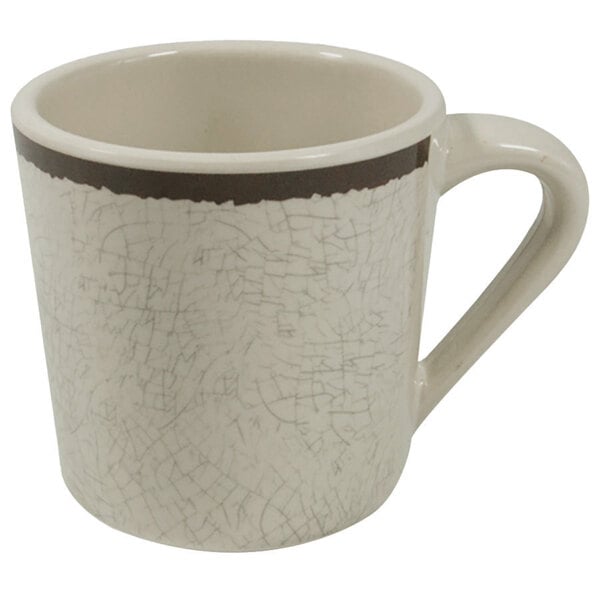 A white coffee mug with a brown rim and handle.