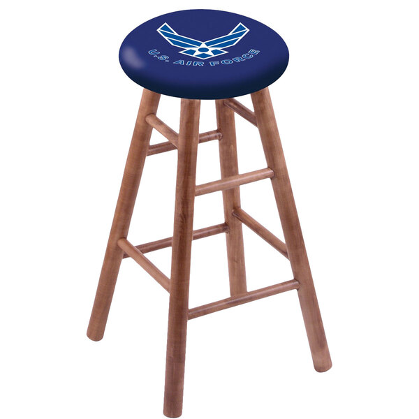 A wooden bar stool with a blue seat and United States Air Force logo.