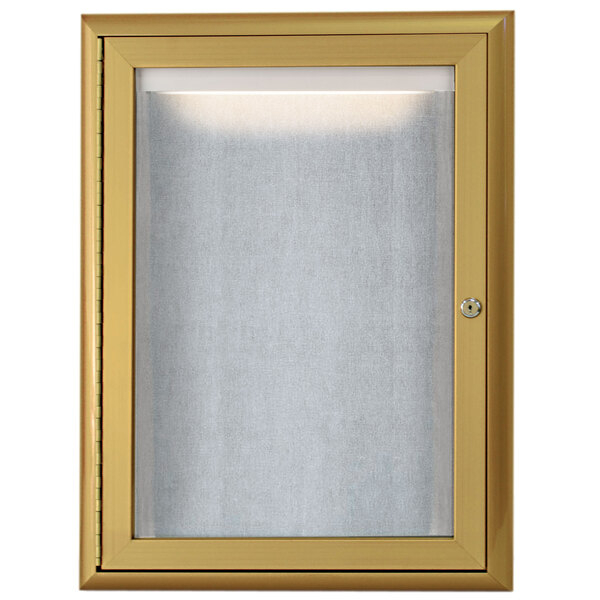 A gold framed glass door on an Aarco bulletin board.