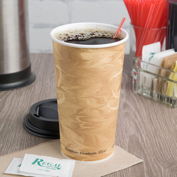 A Solo Mistique paper hot cup on a table with a drink inside.