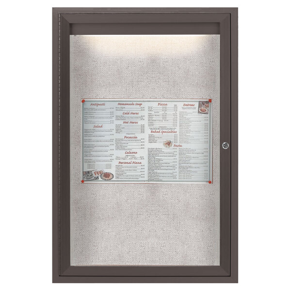 An Aarco bronze enclosed bulletin board with LED lighting displaying a menu with a price list.