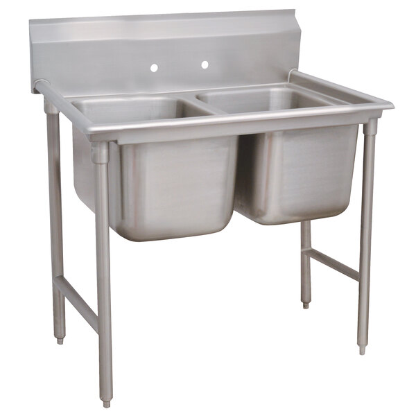 An Advance Tabco Regaline stainless steel sink with two bowls.