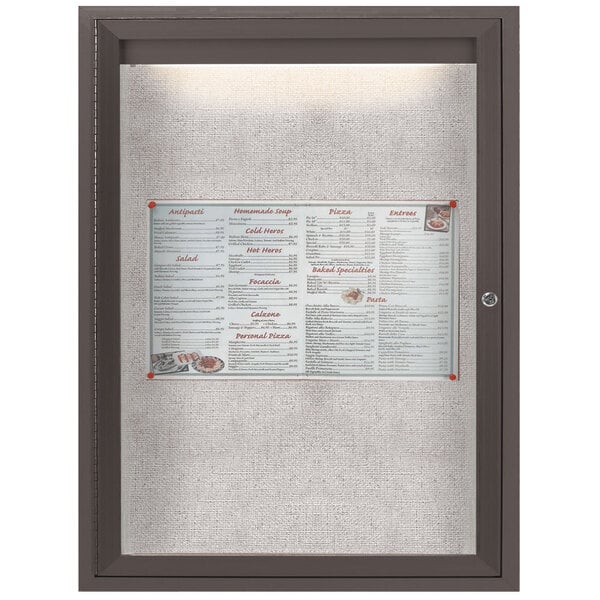 A bronze Aarco bulletin board with a menu inside.