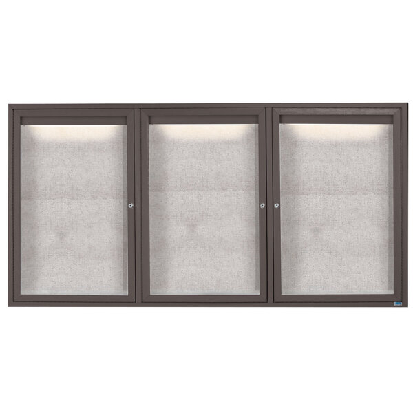 A white rectangular bulletin board with three glass doors and a black frame.