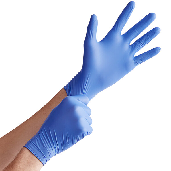 a pair of hands wearing blue gloves