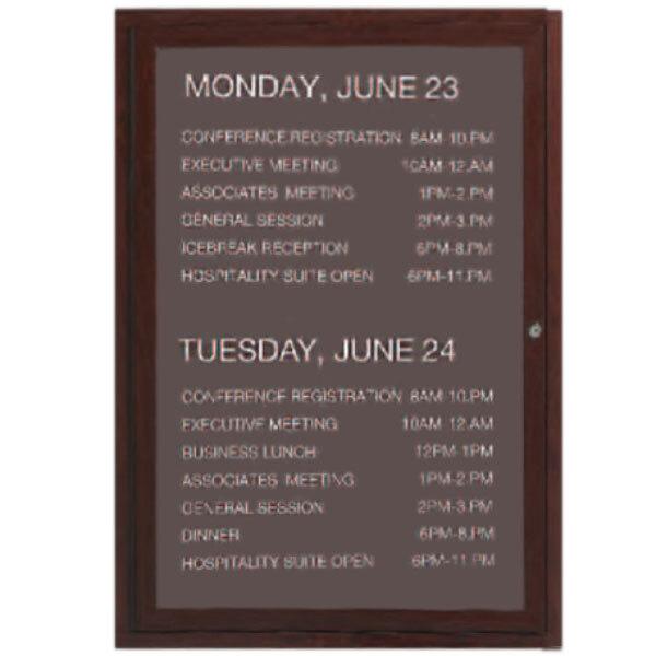 An Aarco outdoor directory board with a cherry wood finish and black letter board with white text.