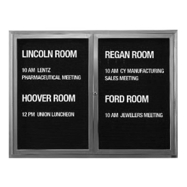 A black Aarco message center door with white text on a black letter board.