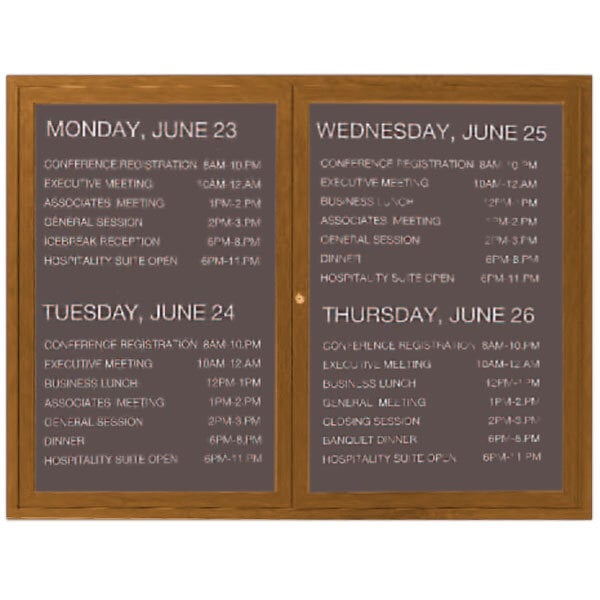 An Aarco outdoor directory board with an oak finish and black vinyl lettering displaying a schedule.