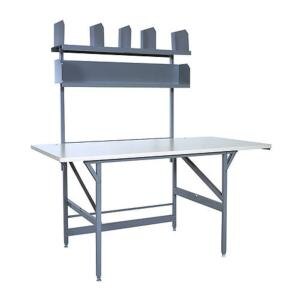 A grey work table with a shelf above it.