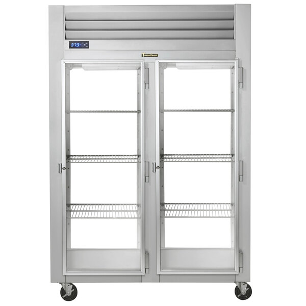 A Traulsen 2-door glass reach-in refrigerator with stainless steel shelves.