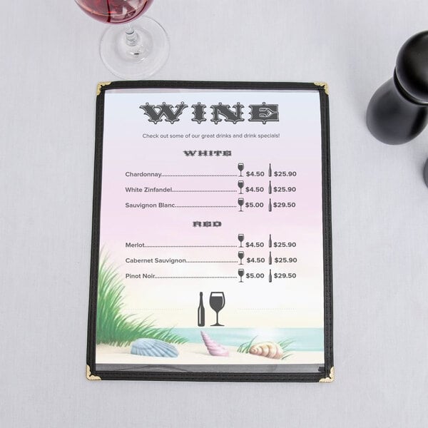 An 8 1/2" x 11" seafood themed menu with a coral design on a counter with a glass of wine.