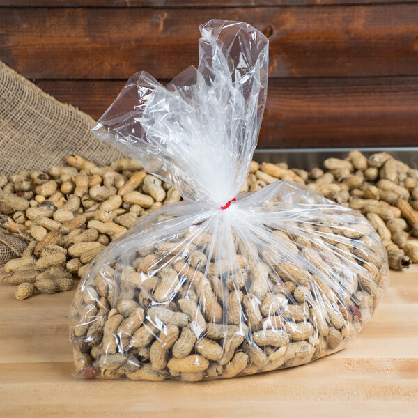 A LK Packaging plastic food bag of peanuts on a table.