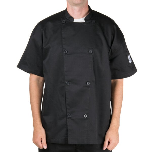 A man wearing a black Chef Revival short sleeve chef jacket.