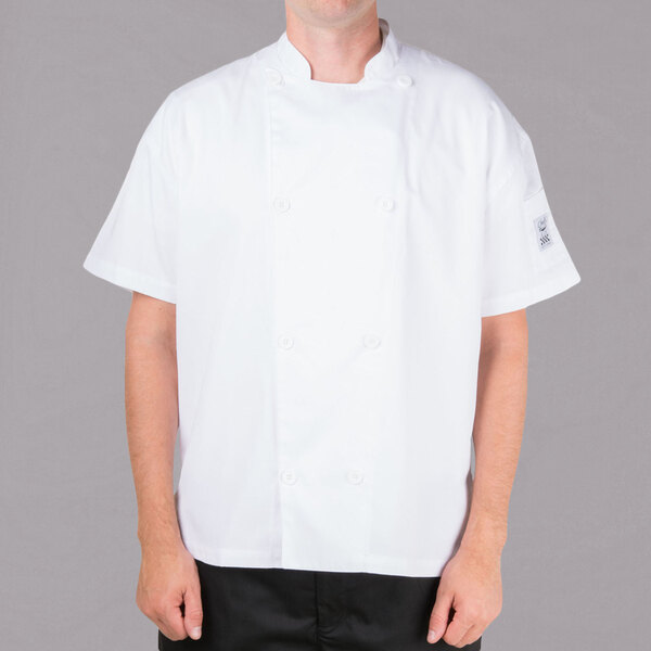 A man wearing a white Chef Revival short sleeve chef jacket with mesh back.