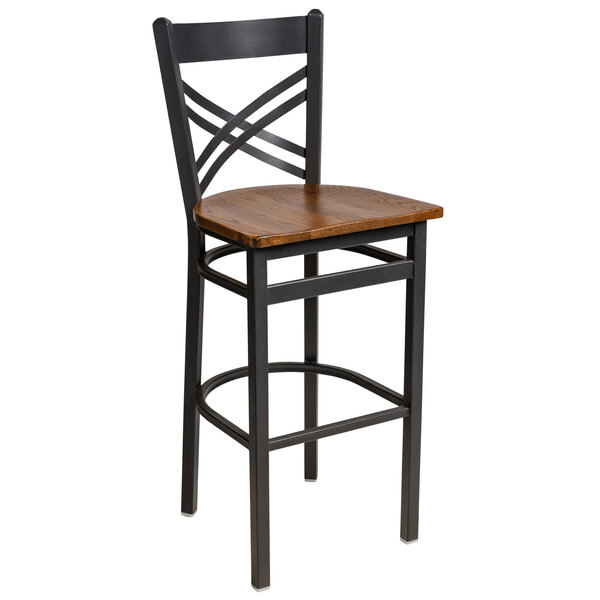 A black steel BFM Seating bar height chair with a wooden seat and cross back.