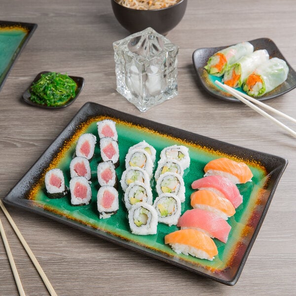 A Libbey stoneware platter with sushi on a table.